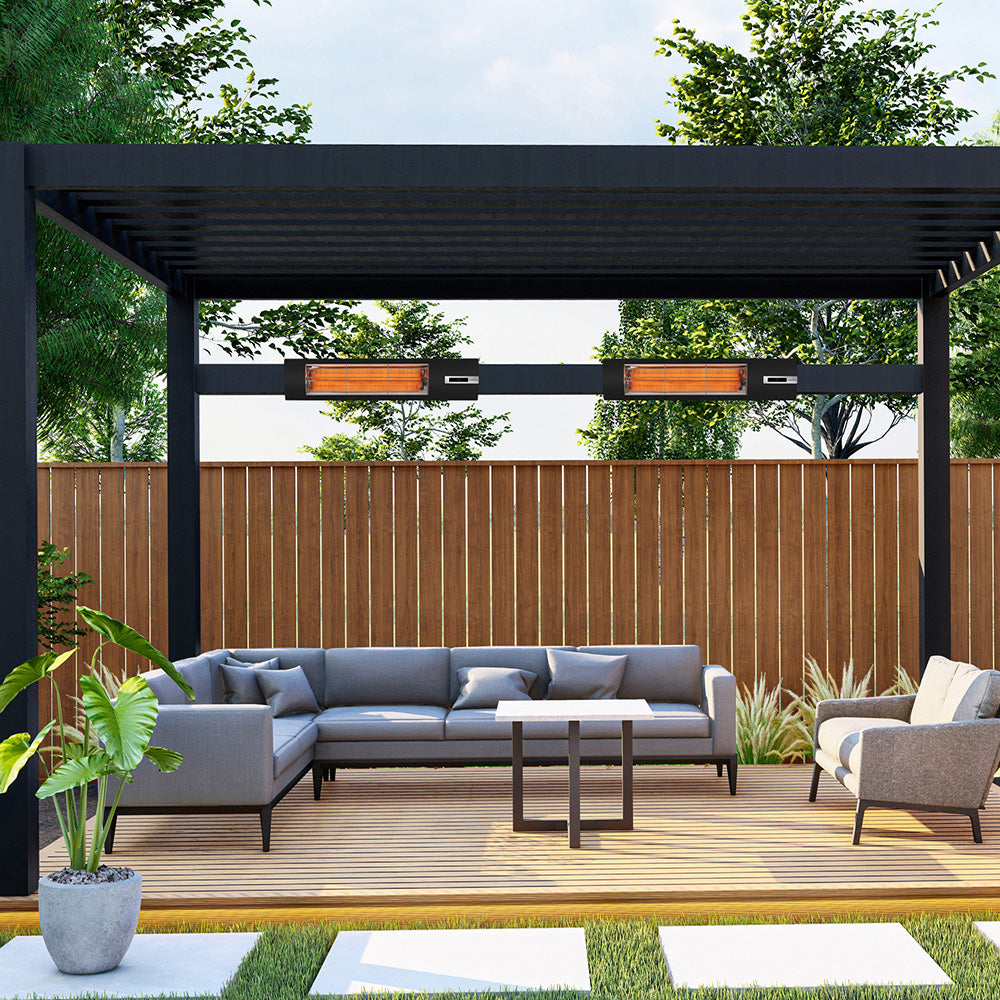 Outdoor patio with gray sectional sofa, coffee table, and chairs under a black pergola. Veito infrared heaters are hung from the pergola.
