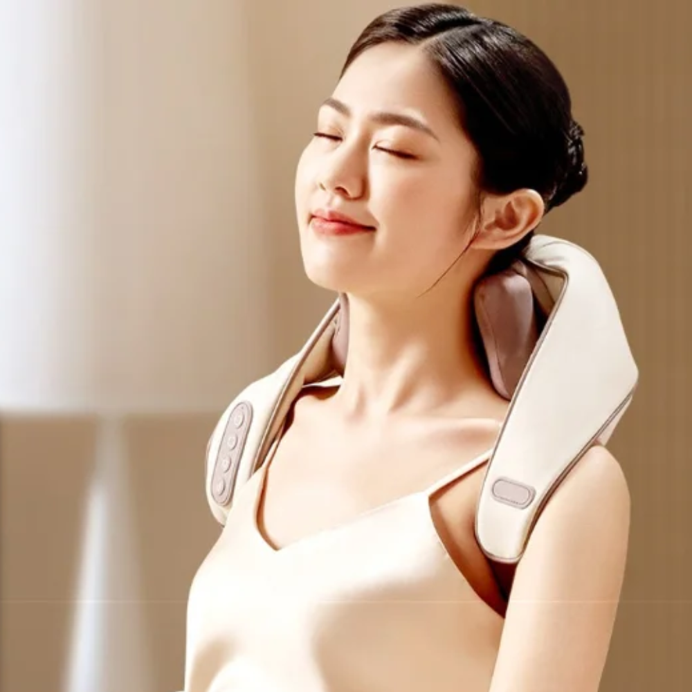 A woman relaxing with the BACKplus® Cordless Platinum Shiatsu Massager.