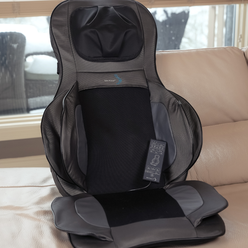 Backplus Shiatsu Neck and Back Massager With Air Compression Chair Cushion placed on a beige couch