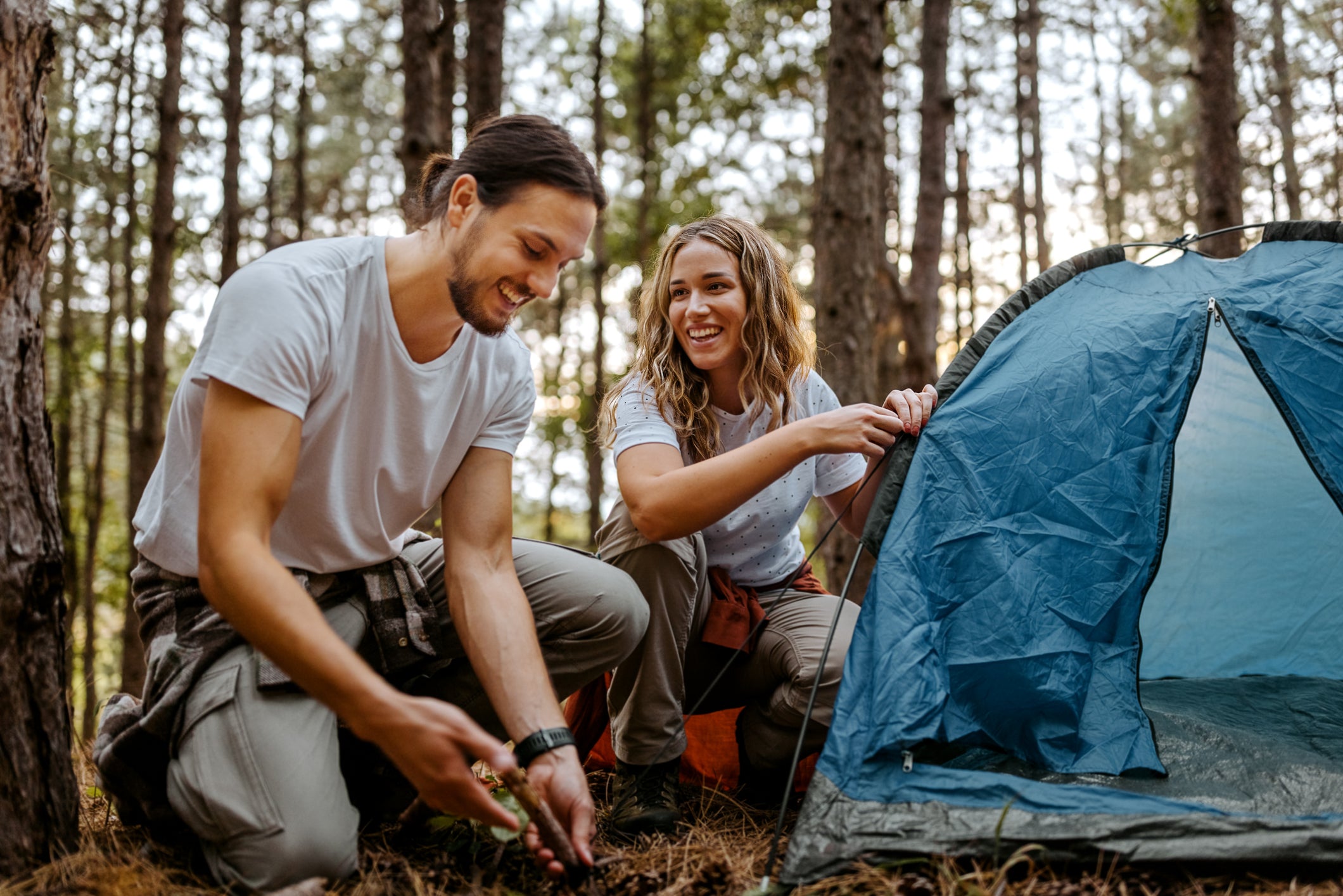 Couple setting up a tent