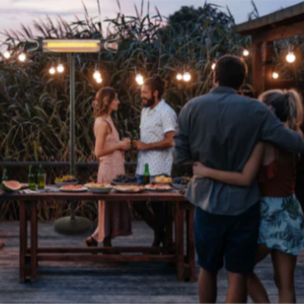 TIVA Electric Infrared Indoor/Outdoor Electric Heater with remote in background at a gathering