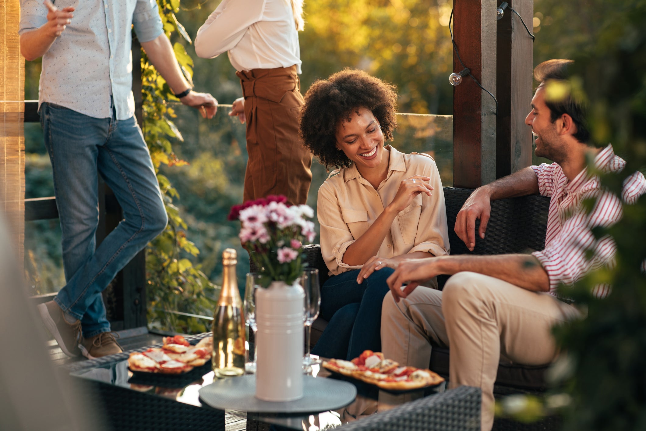 Couple enjoying food and drinks on a patio
