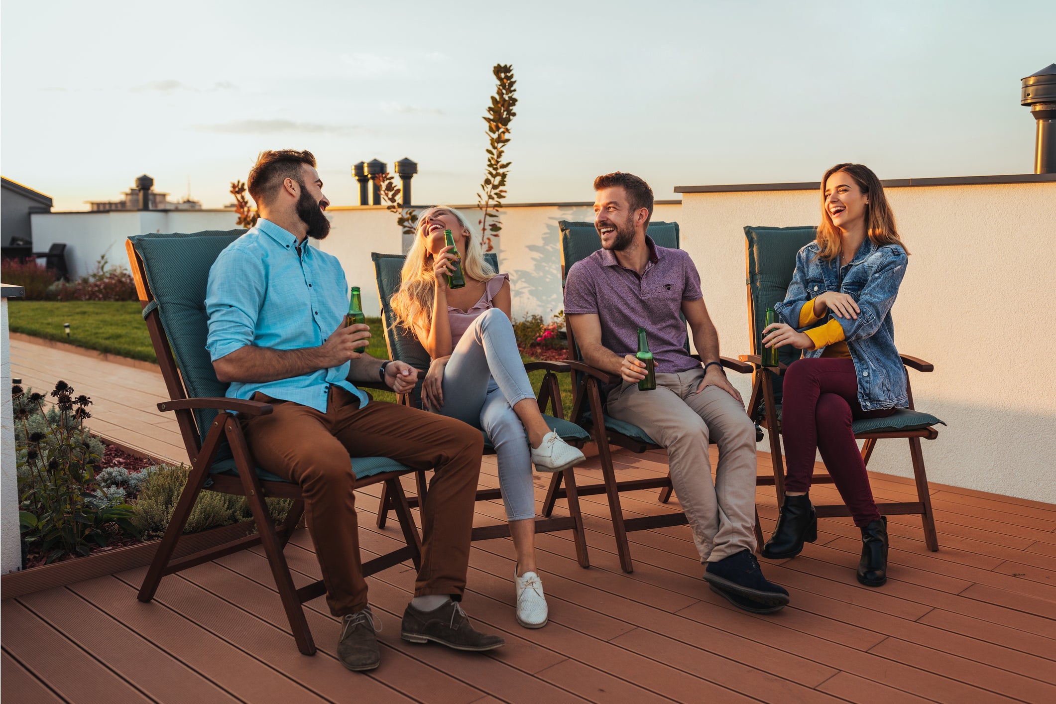 Group of friends enjoying drinks sitting outside