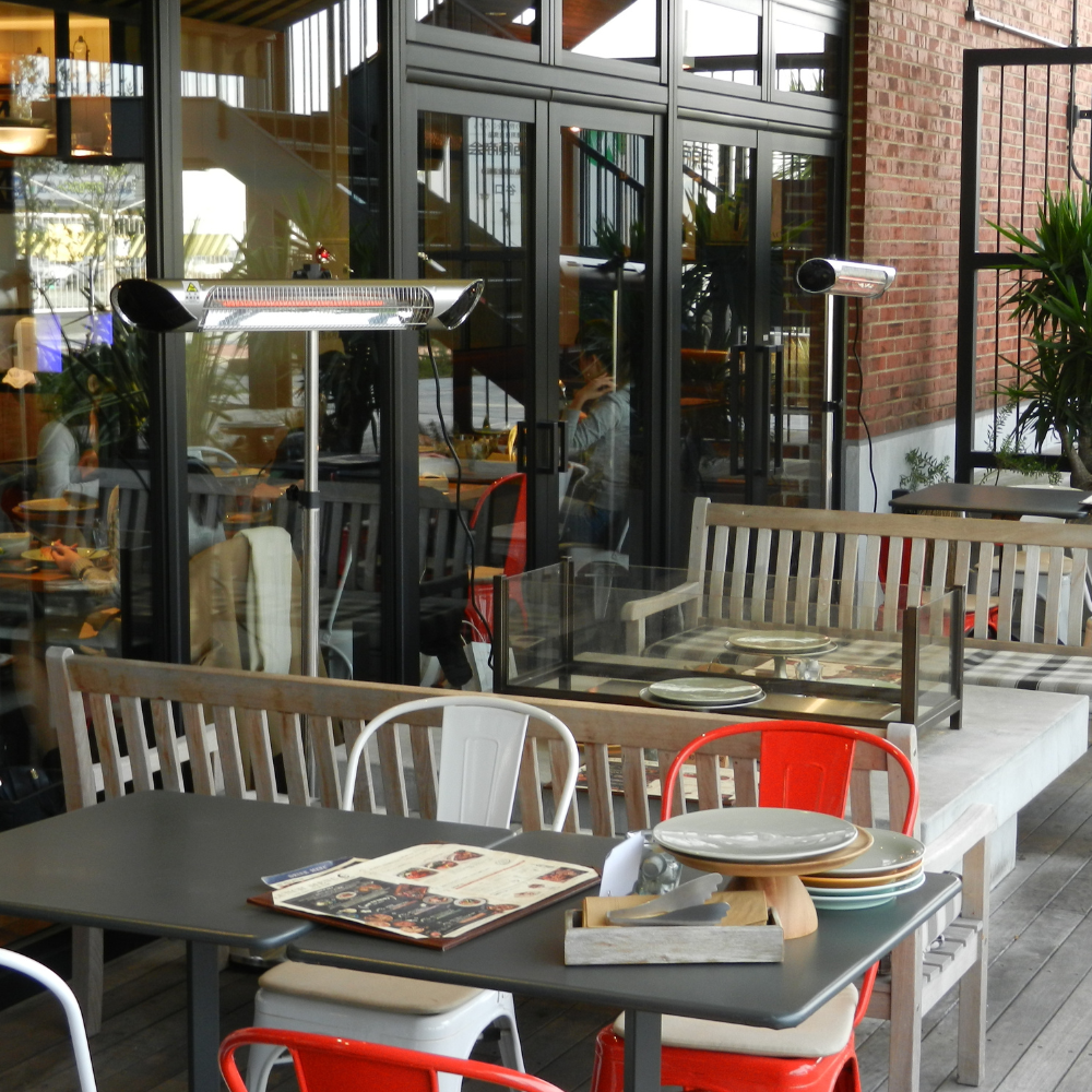 iQ Heat® Wave Space Heater standing by outdoor restaurant patio