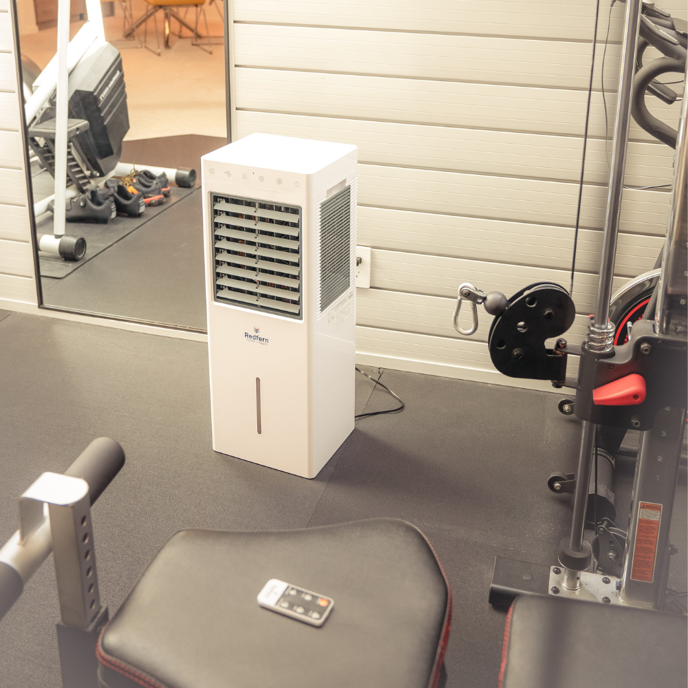 iQ Pure Breeze Air Cooler Evaporative Cooler next to fitness equipment