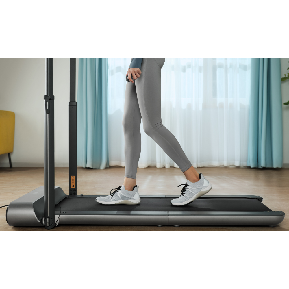 Woman walking on iQ Slim Tread® Foldable Treadmill