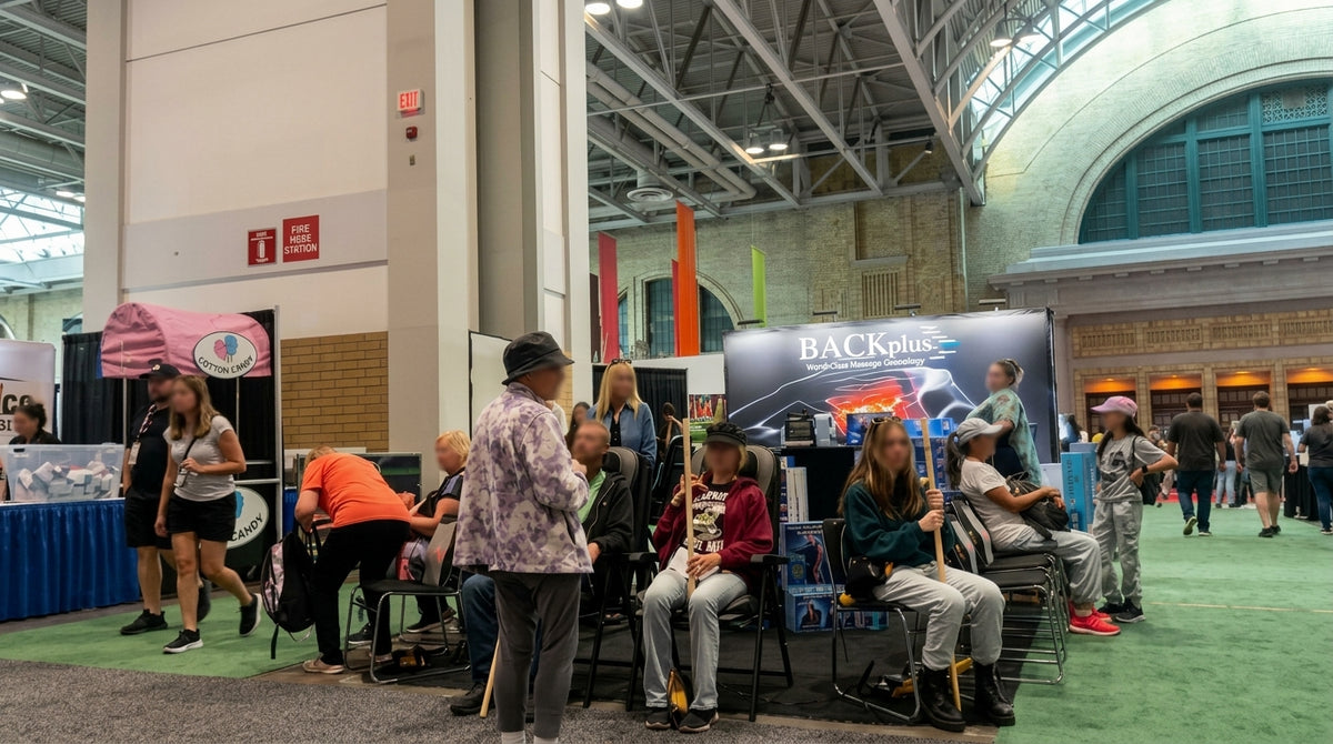 Customers experiencing BACKplus massage products during a live demonstration
