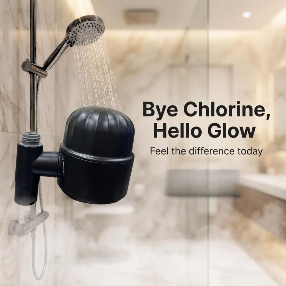 Shower head with a black filter labeled 'Bye Chlorine, Hello Glow' in a bathroom setting.