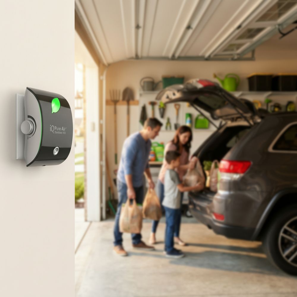 Family unloading groceries from a car in a garage with a iQ Pure Air air purifier on the wall.