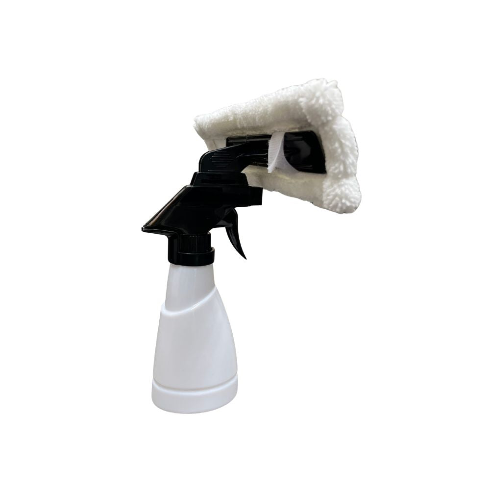 White spray bottle with black nozzle and white cloth on a white background