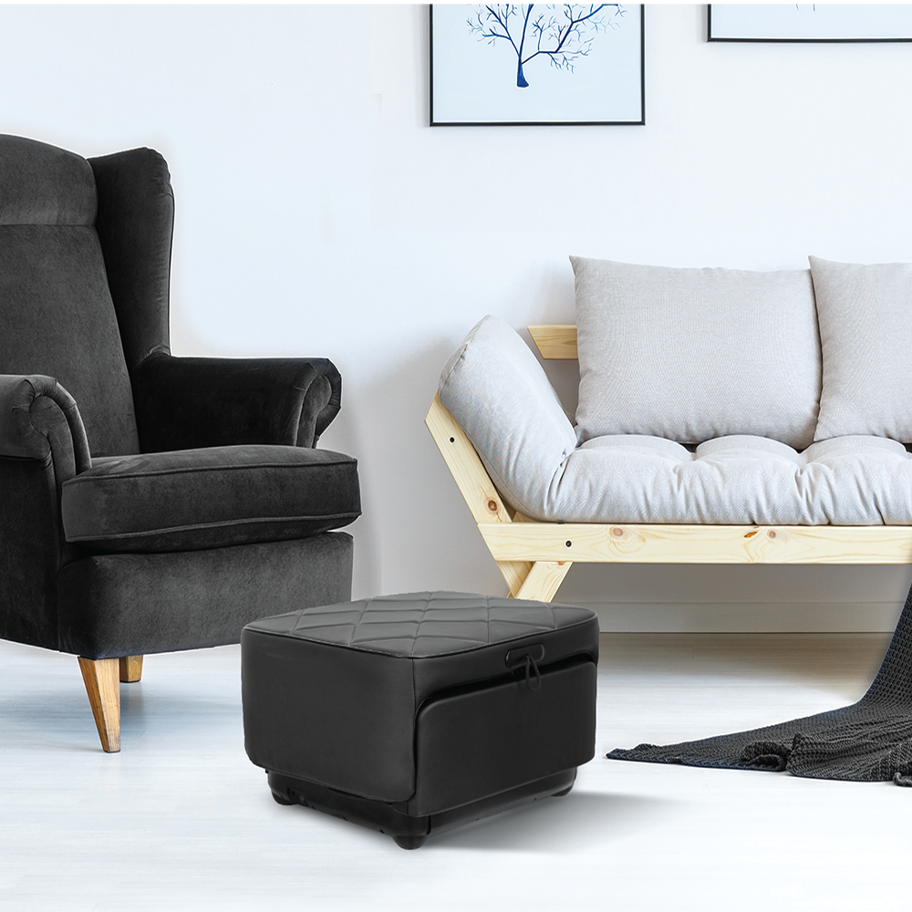 Living room with a gray armchair, wooden sofa, and a compact foot massager disguised as a stylish ottoman.