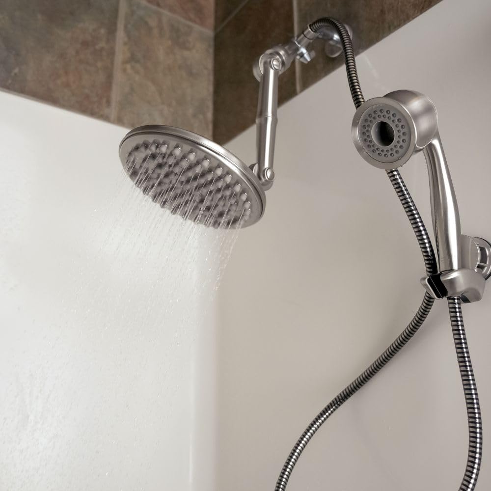 Chrome shower head and handheld shower attachment on a tiled bathroom wall.