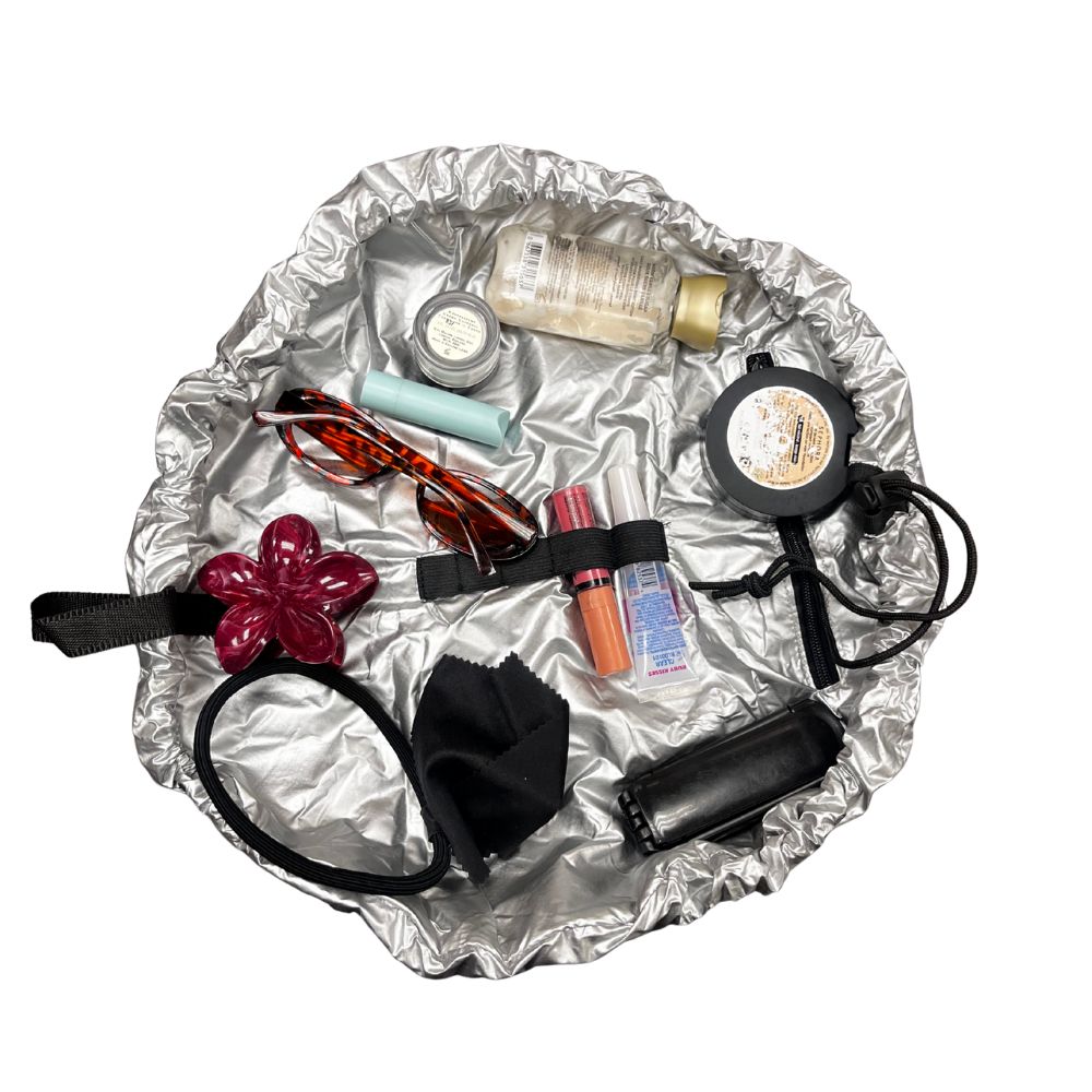Collection of beauty products on a silver Nifty Sac background