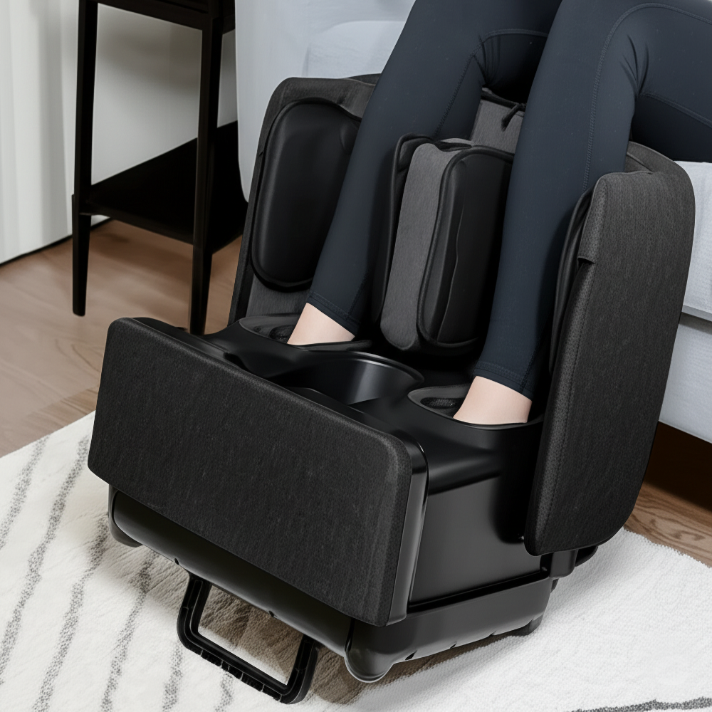 Person using a black foot and leg massager in a home setting.