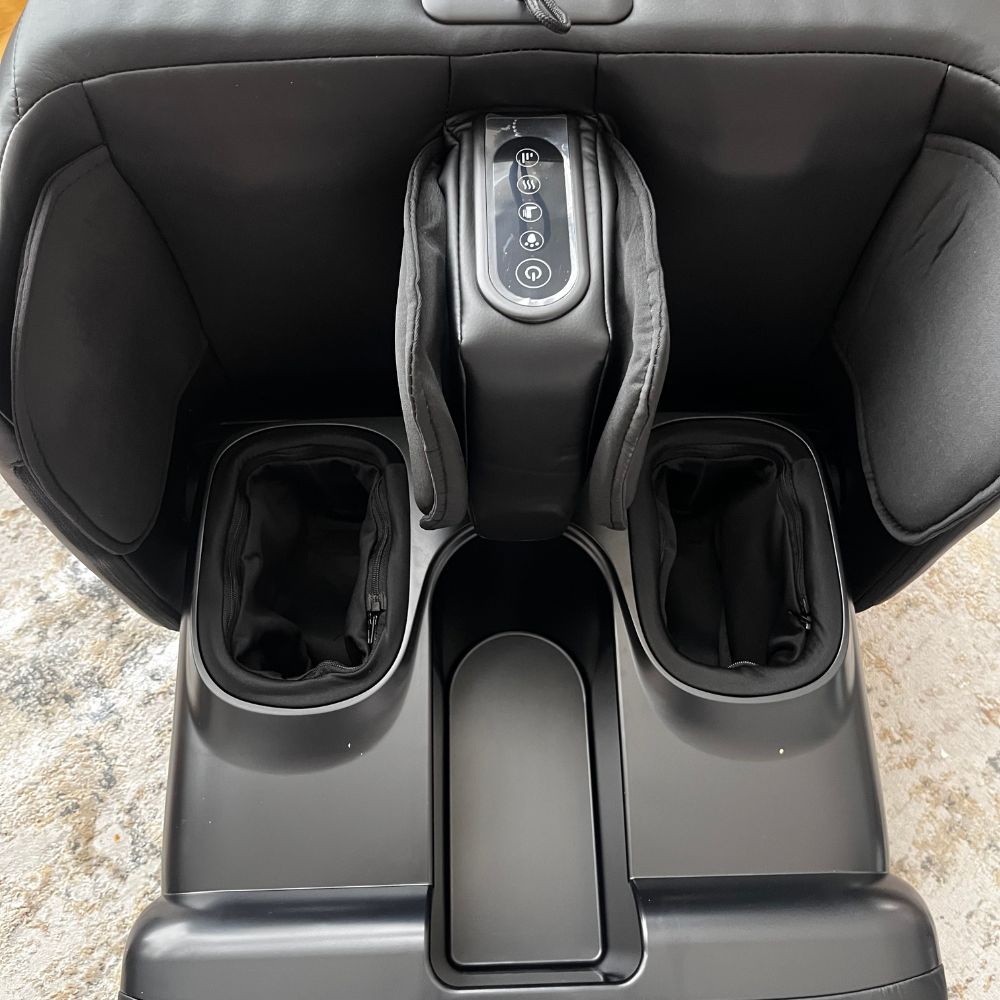 Black massage chair with control panel and leg openings with compression