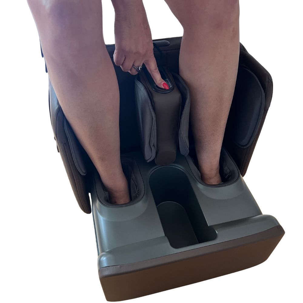 Person using a foot massage machine on a white background