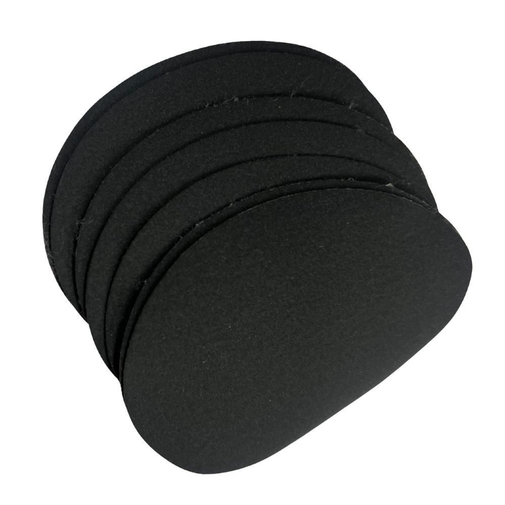 Set of black circular Sphinx hair remover pads on a white background
